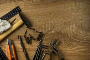 Tools for a custom home renovation on a wooden background.